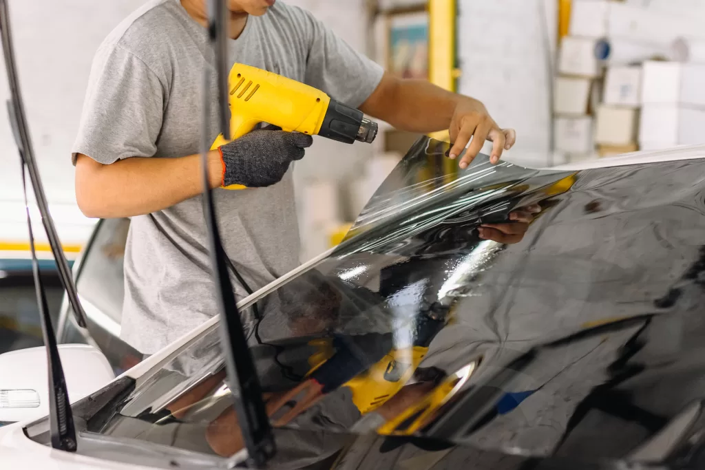 Professional Installer tinting in vehicle at KL Tint Studio