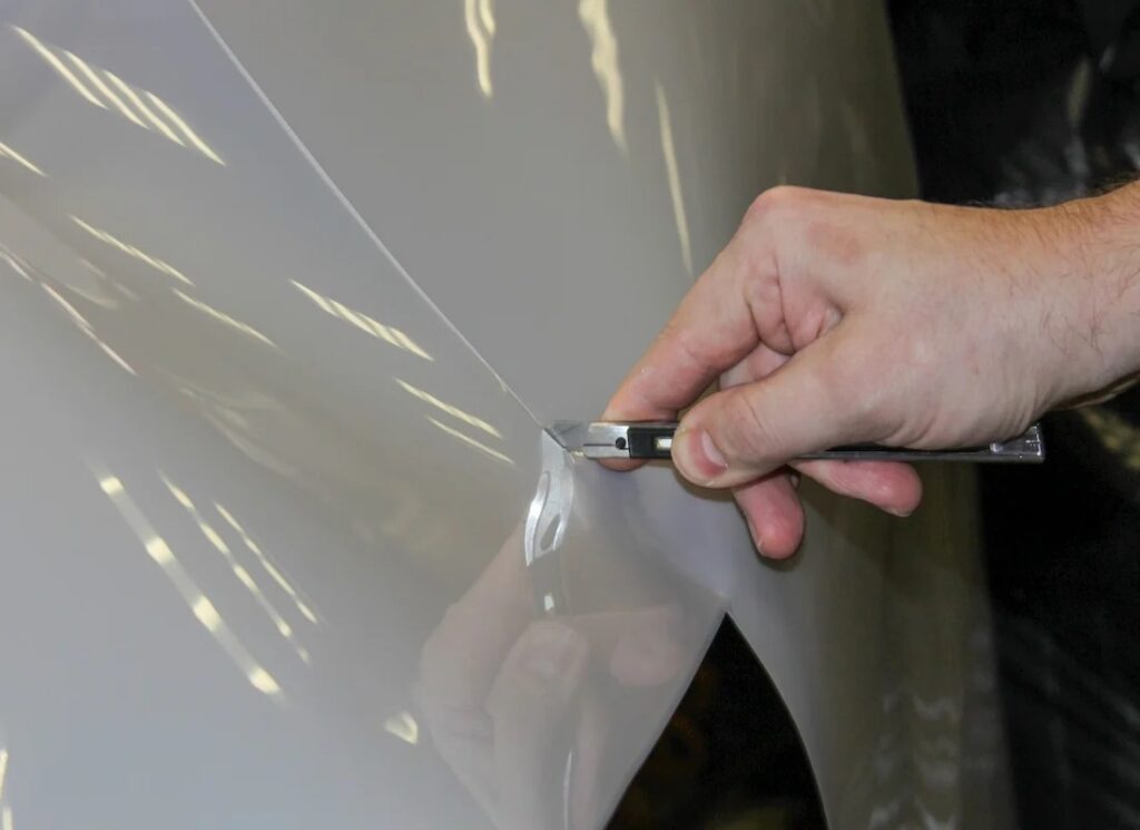 Car with paint protection film preventing scratches and chips on the surface