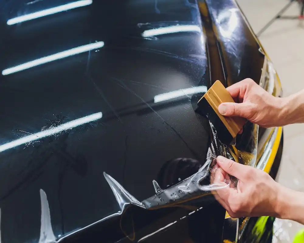 Car with paint protection film providing self healing for the paintwork